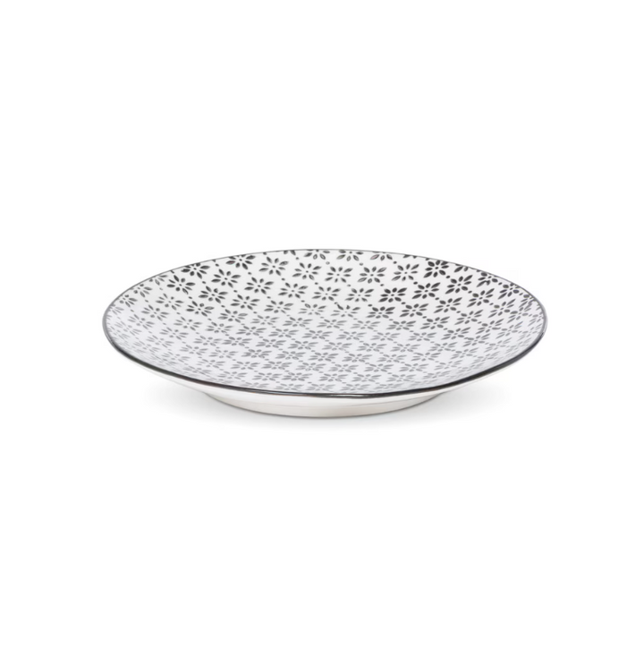 Decorative plate with black floral pattern on a white background