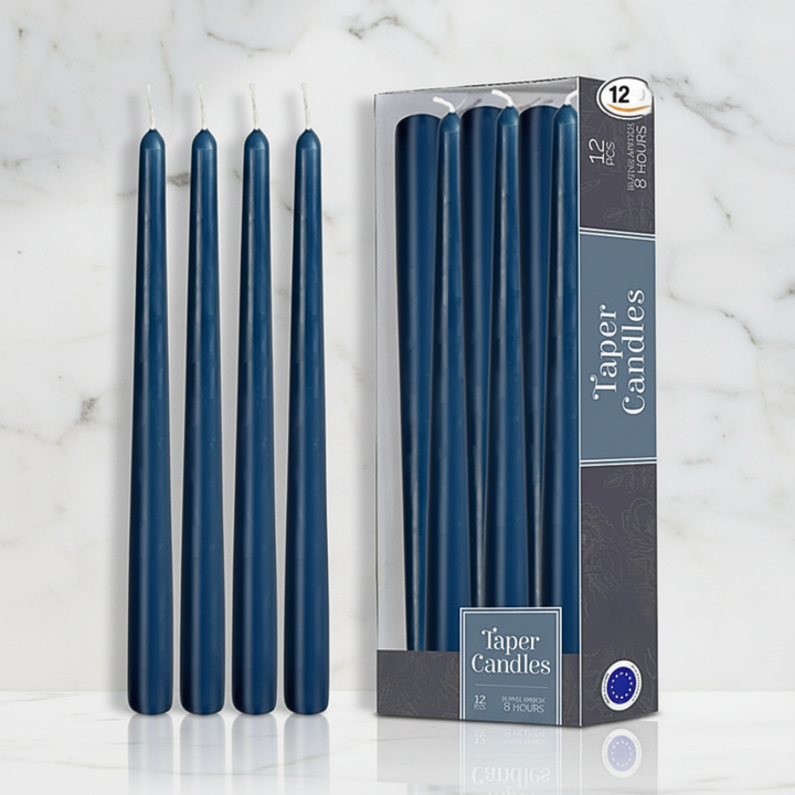 Set of 12 blue taper candles with packaging on a marble surface