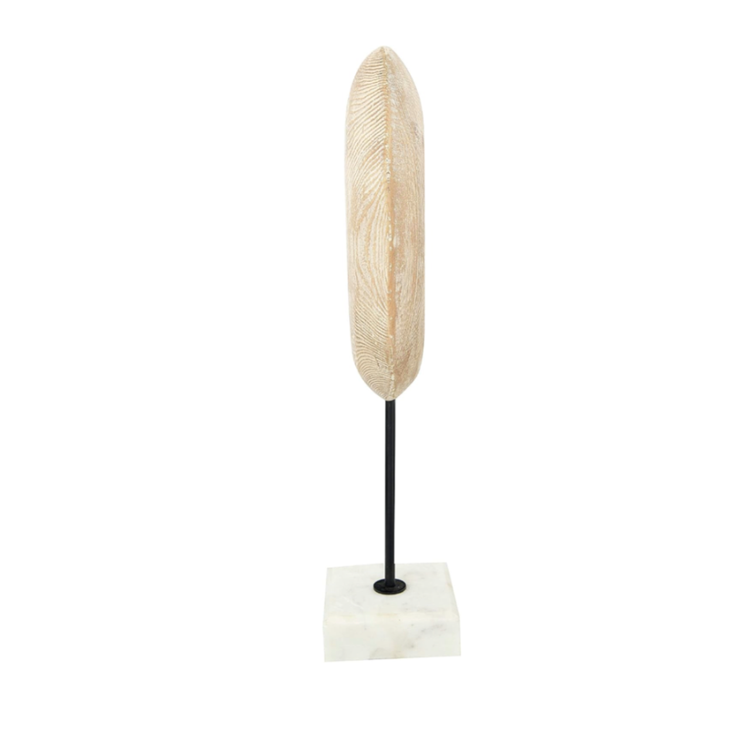 Decorative abstract art figurine on a marble stand with a white base against a white background