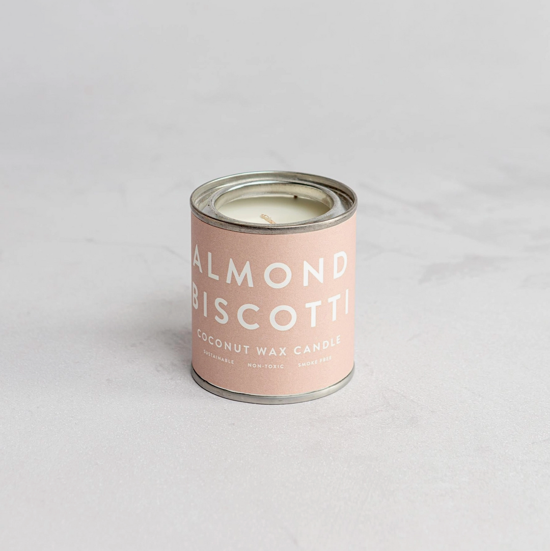 A collection of Conscious Coconut Wax Candles in various colors, displayed in reusable and recyclable paint tins.