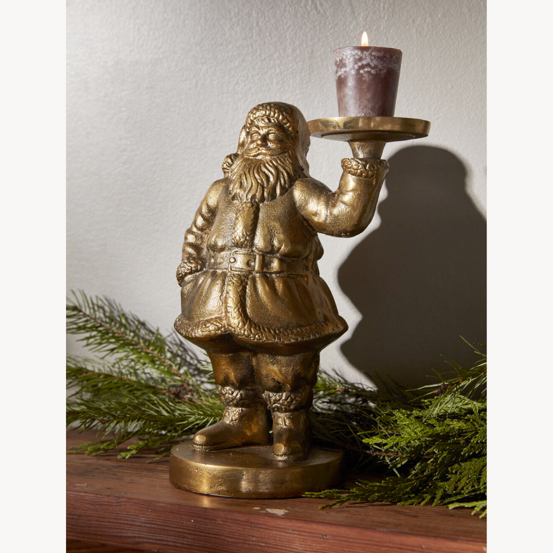 Bronze metal Santa figurine holding a candle 