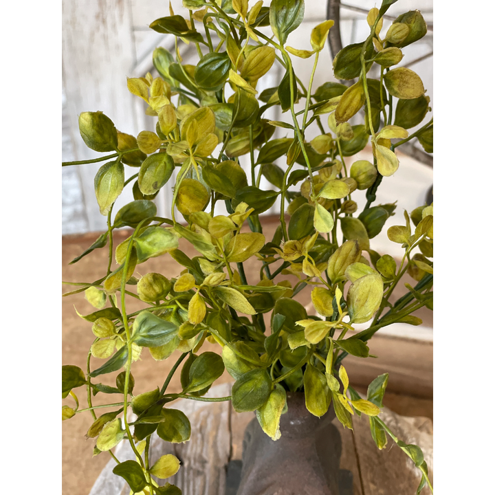Artificial green plant with a blurred background
