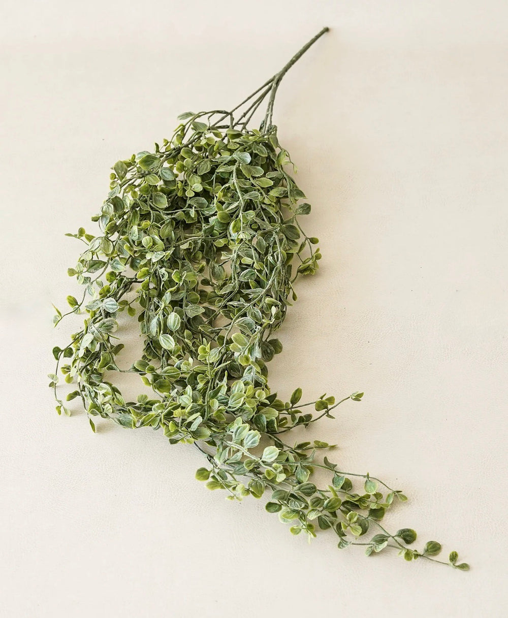 Artificial green leaf garland on a white background