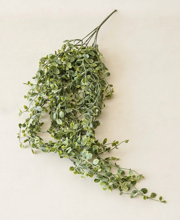 Artificial green leaf garland on a white background