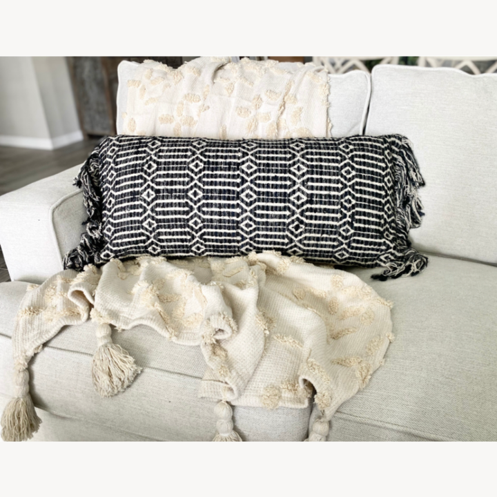 Decorative pillows and blanket on a white sofa