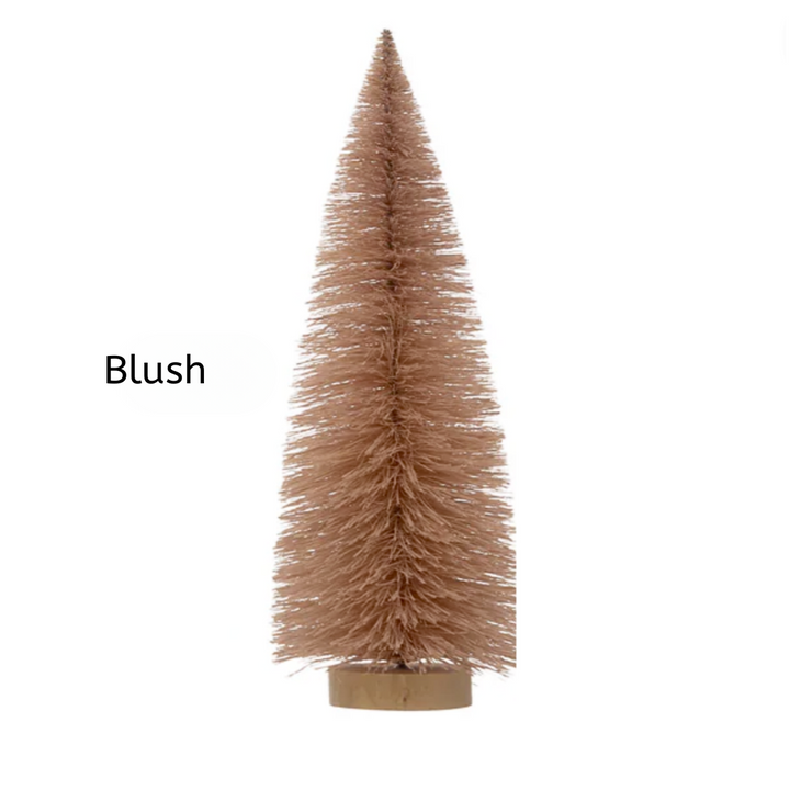 Blush-colored artificial Christmas tree on a white background