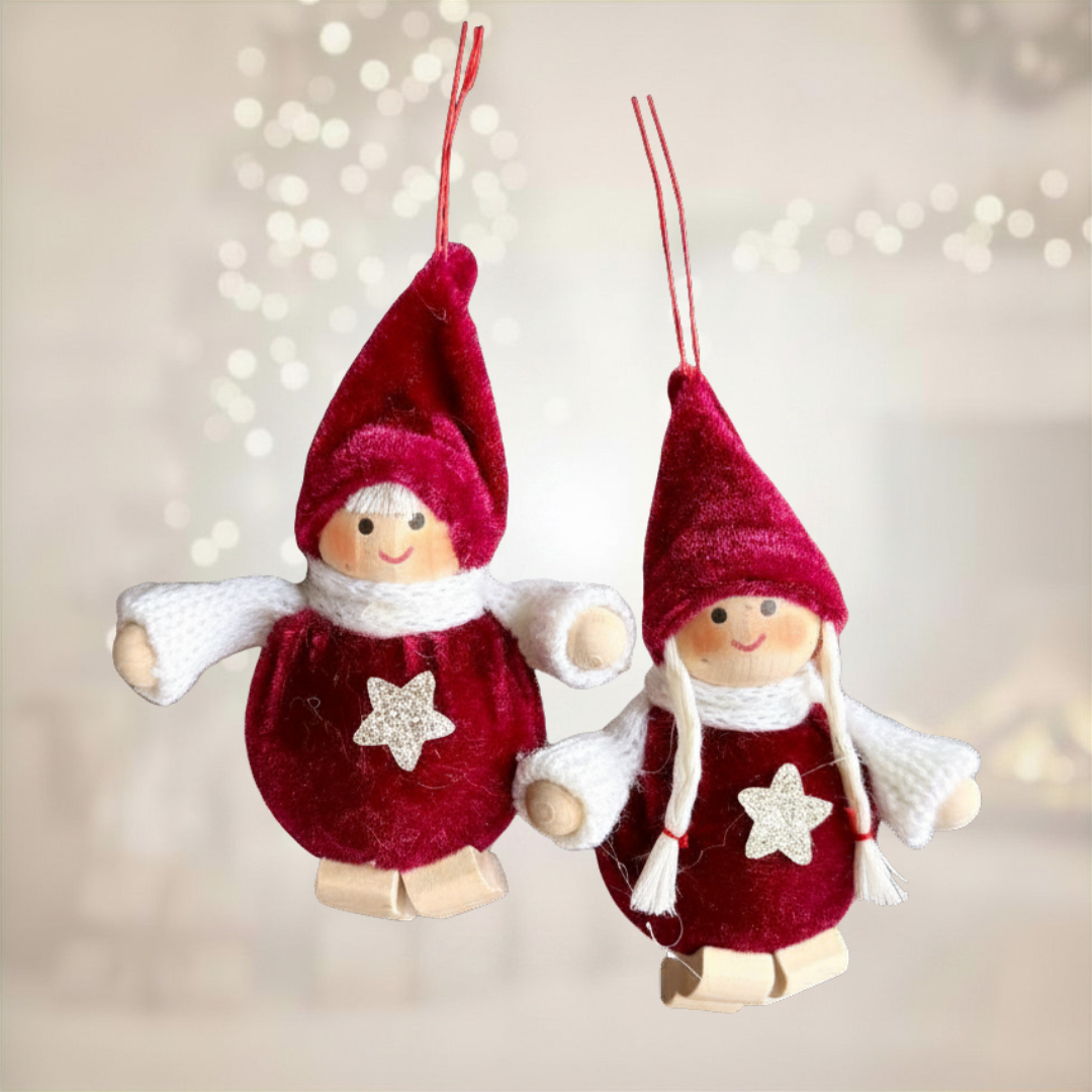 Two red Christmas gnome ornaments with white accents on a blurred light background