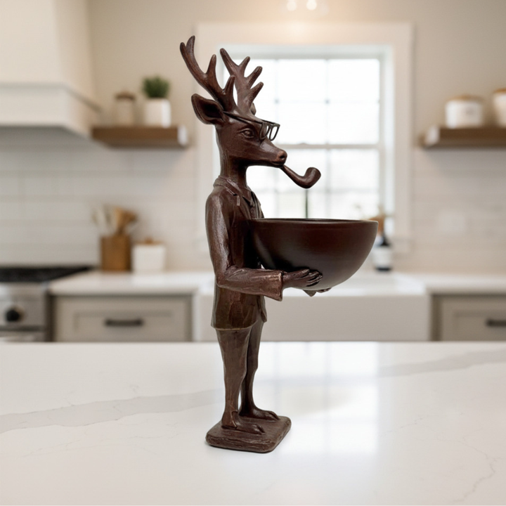Decorative bronze reindeer figure holding a bowl on a kitchen counter.