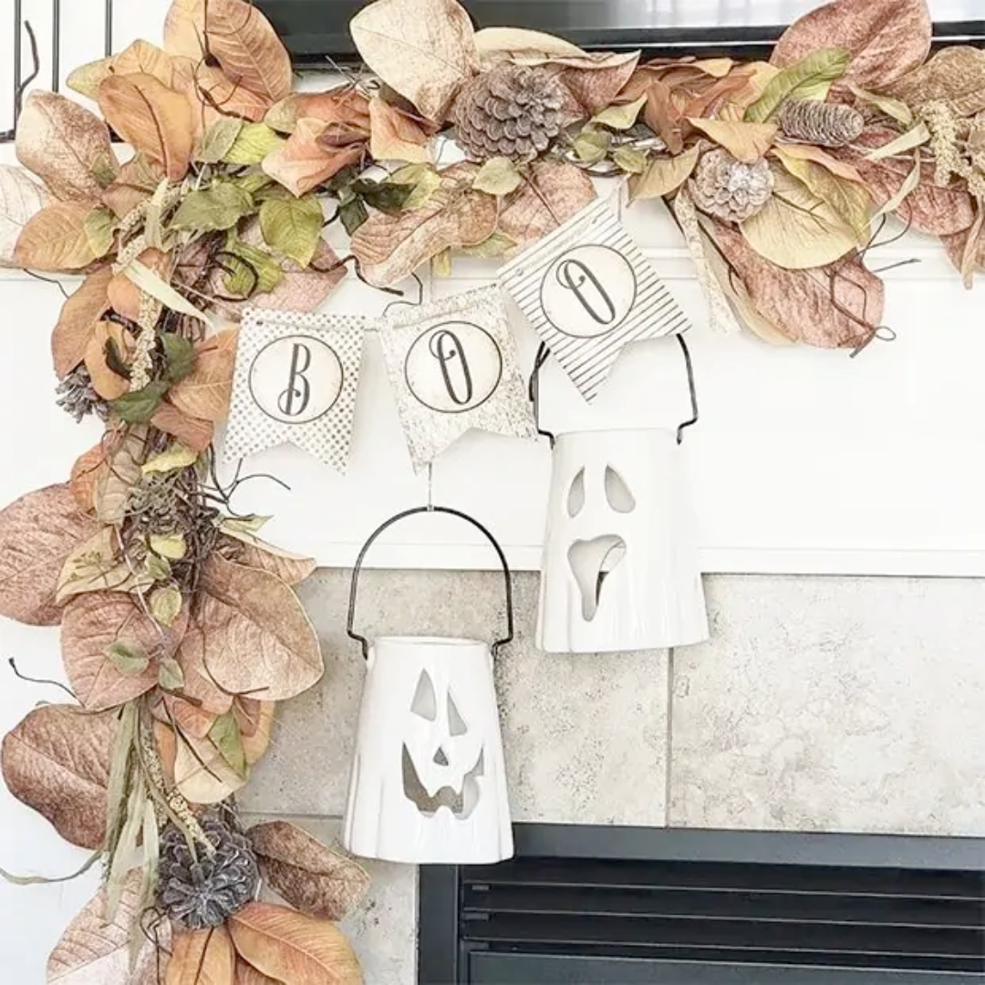 Decorative Halloween wreath with pumpkins, ghosts, and leaves on a fireplace.