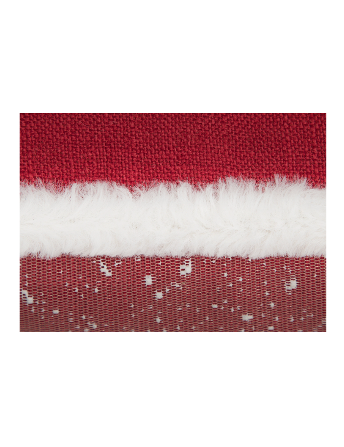 Close-up of red fabric with a white stripe and snowflake pattern on a white background
