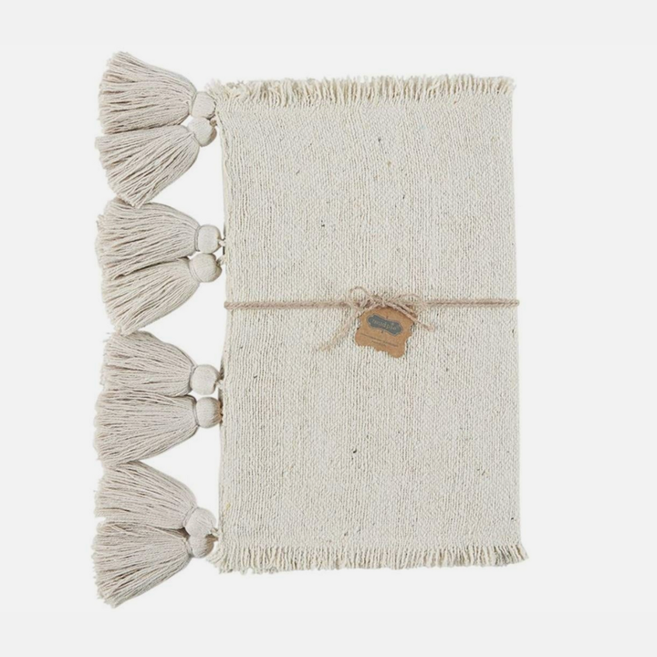 Ivory table runner with tassels on a white background