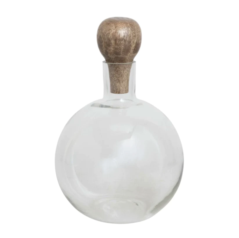 A clear glass decanter with a mango wood stopper.