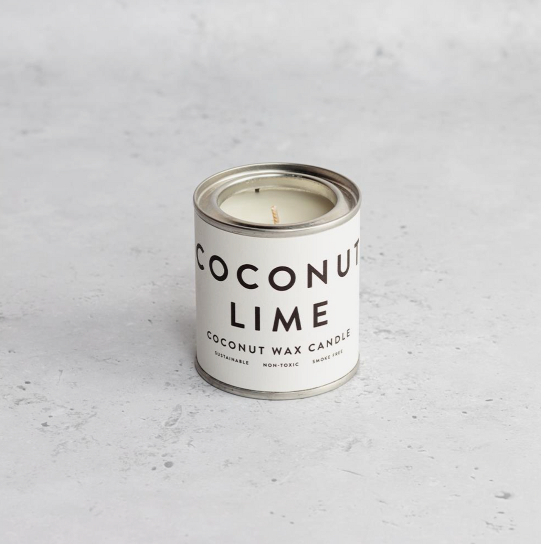 A collection of Conscious Coconut Wax Candles in various colors, displayed in reusable and recyclable paint tins.