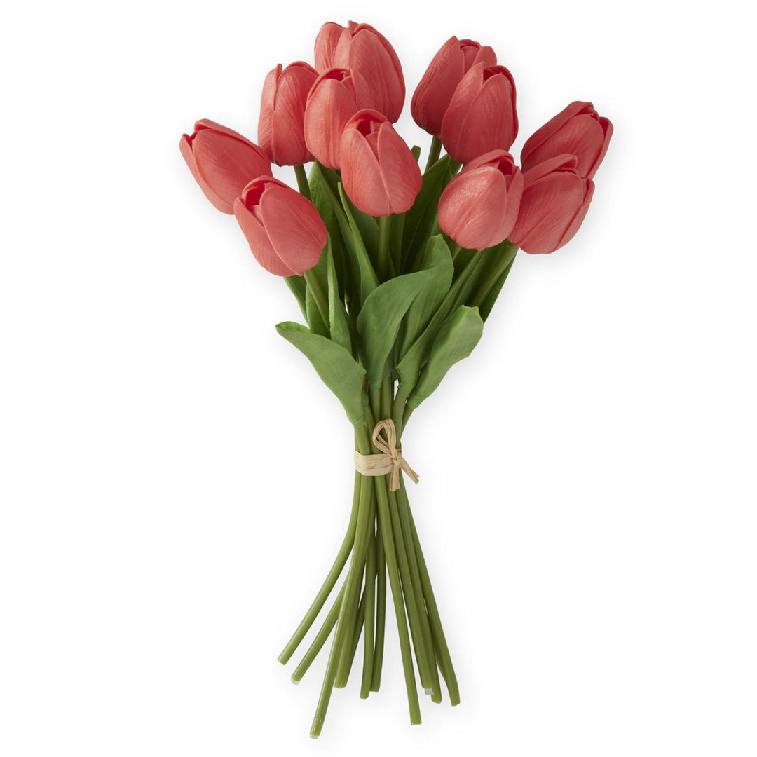 A bouquet of coral-colored artificial tulips tied together with a paper bow.