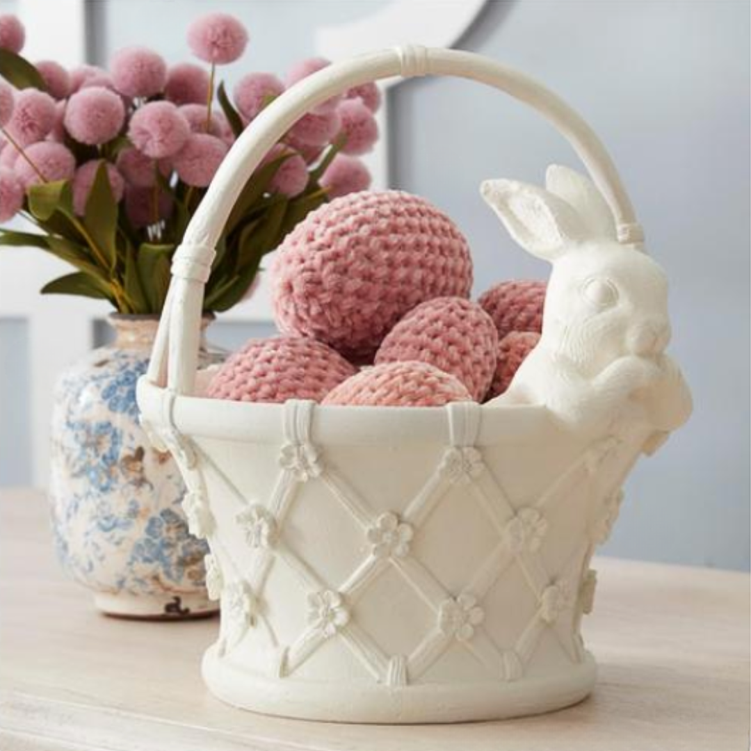 Decorative basket with pink textured Easter eggs and a rabbit face on a light surface.