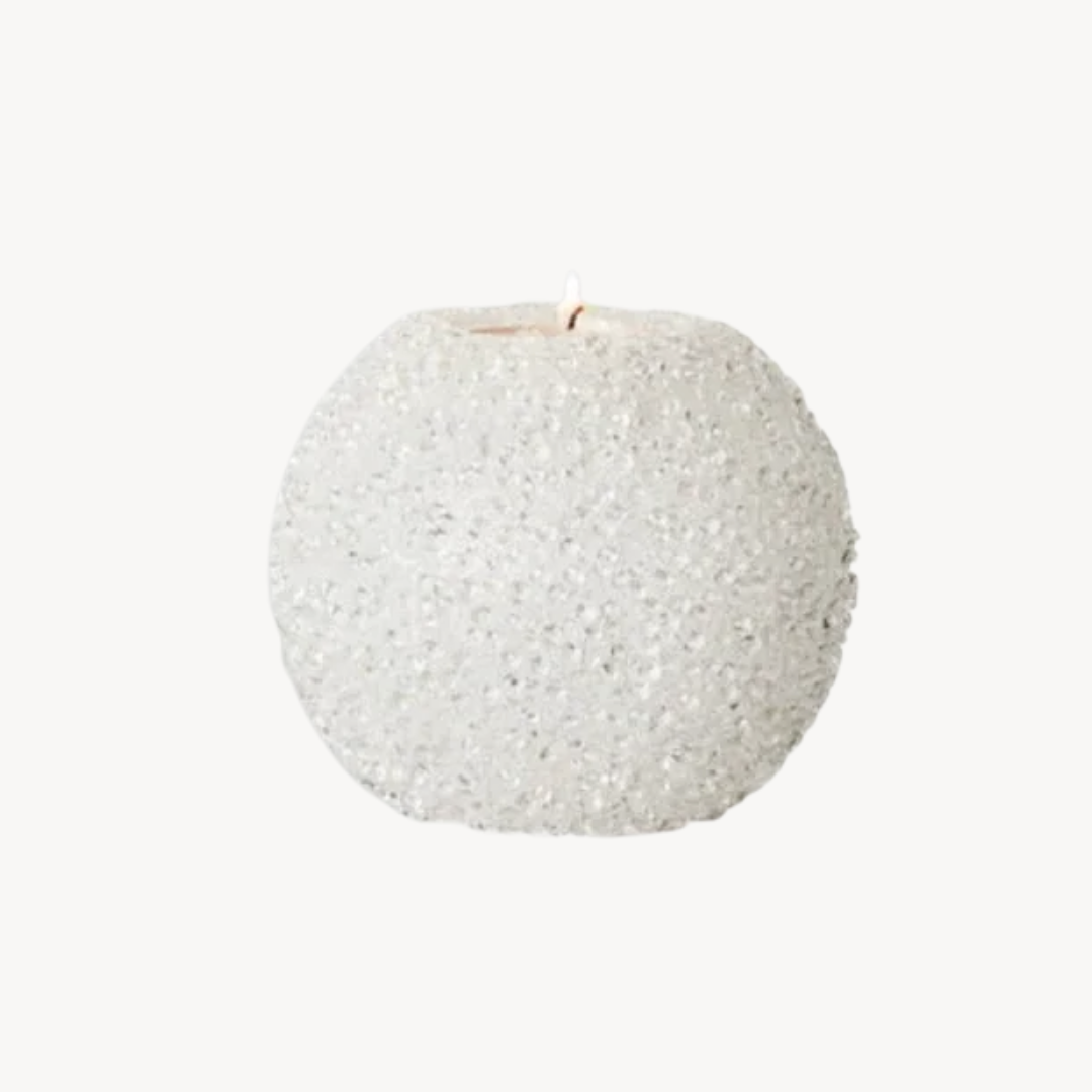 Textured white candle on a white background