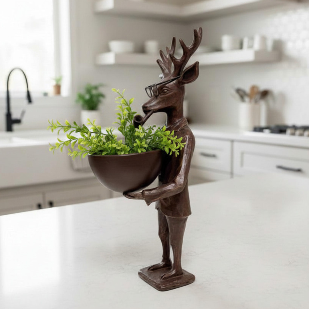Decorative statue of a deer holding a plant in a kitchen setting