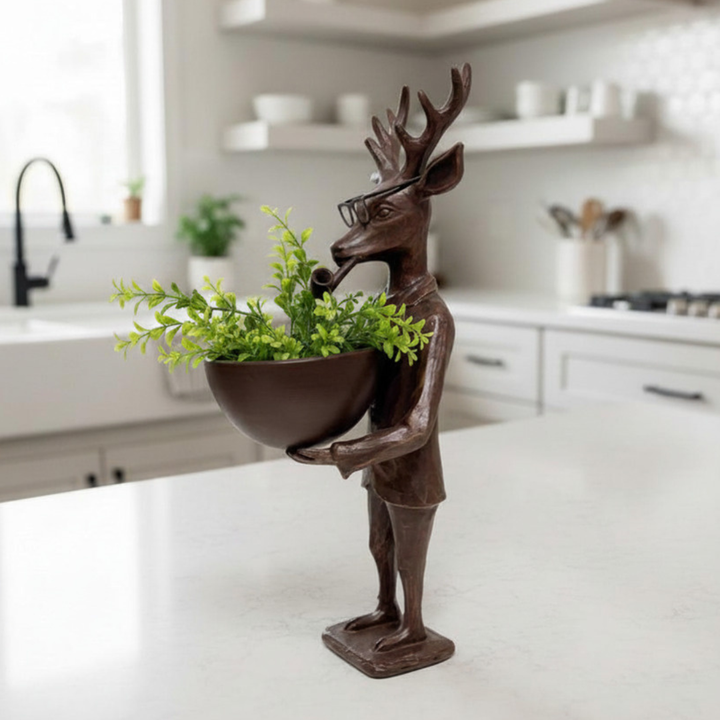 Decorative statue of a deer holding a plant in a kitchen setting