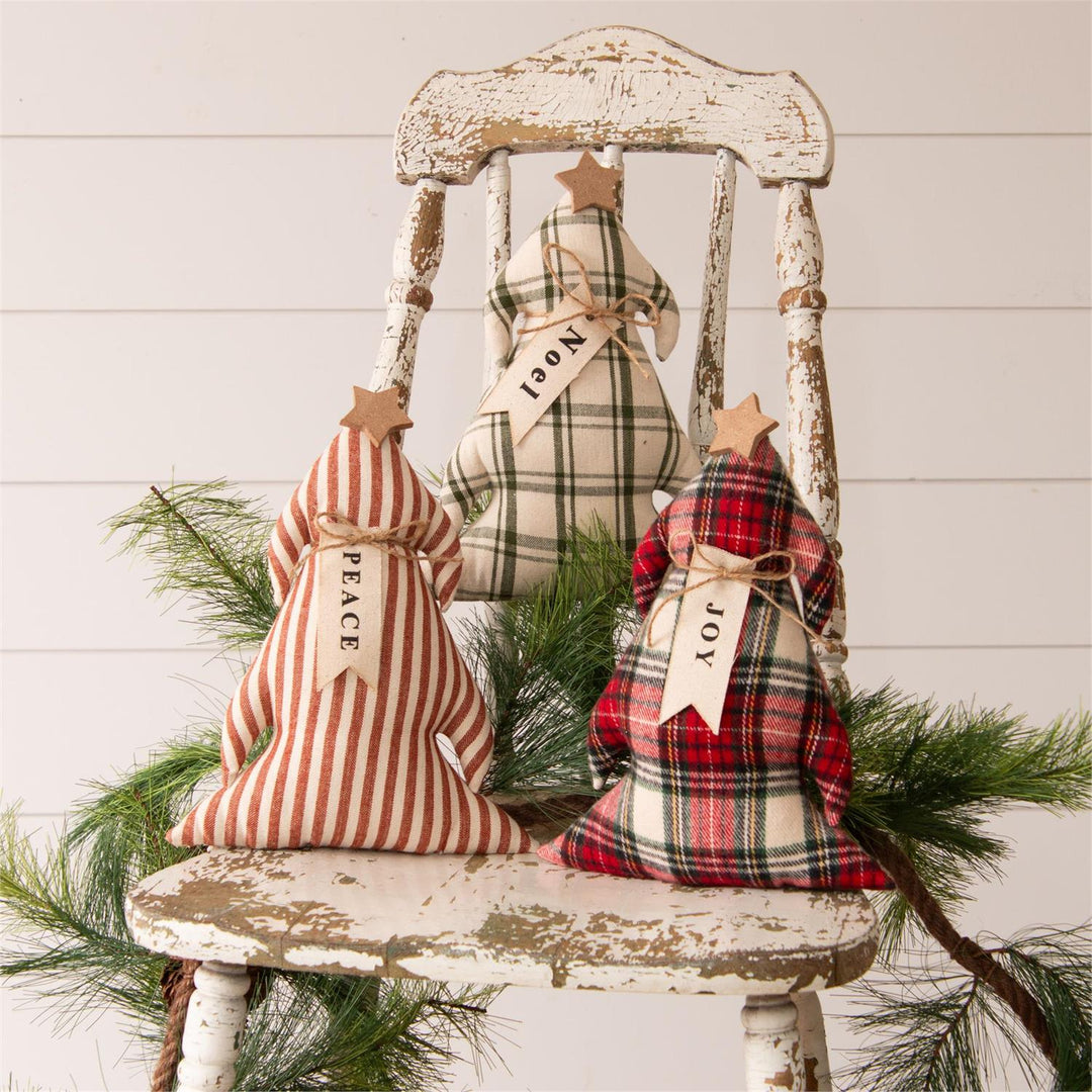Decorative Christmas pillows on a rustic chair with a white wooden background