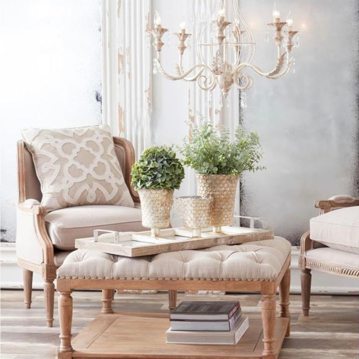 Living room with wooden furniture, a Honeycomb Champagne Mercury Glass Fluted Vase, and a chandelier.