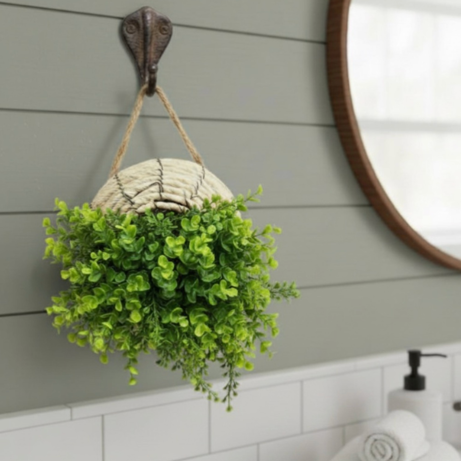 Woven wall basket in a bathroom setting with towels and a mirror.