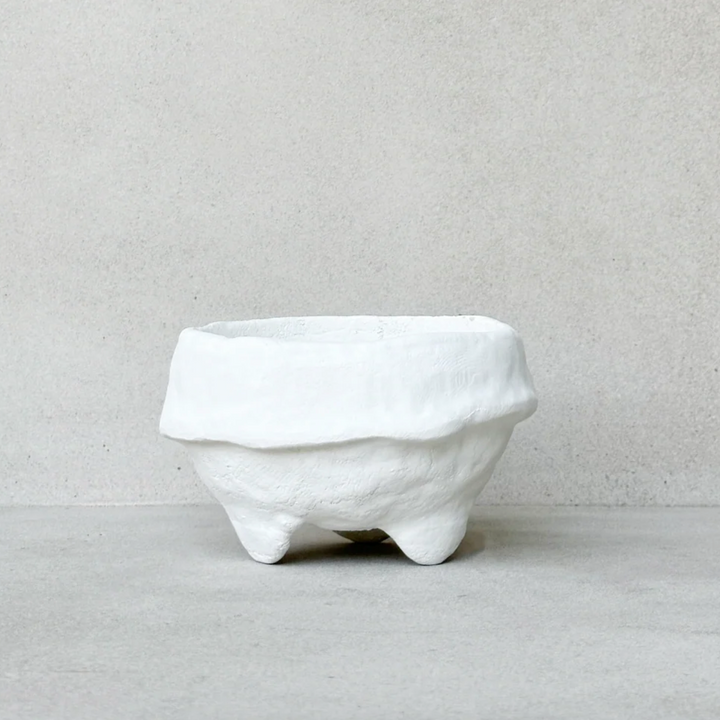 White paper maché footed bowl on a light gray background