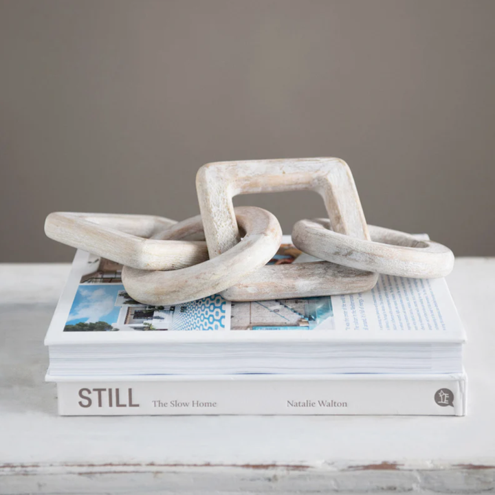 Decorative white links on a stack of books with a gray background