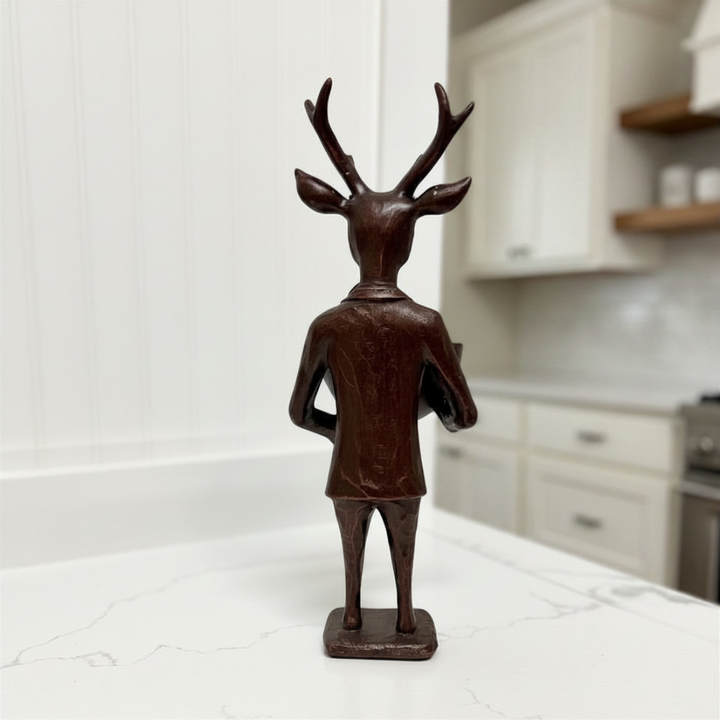 Decorative figurine of a deer with humanoid body on a kitchen counter