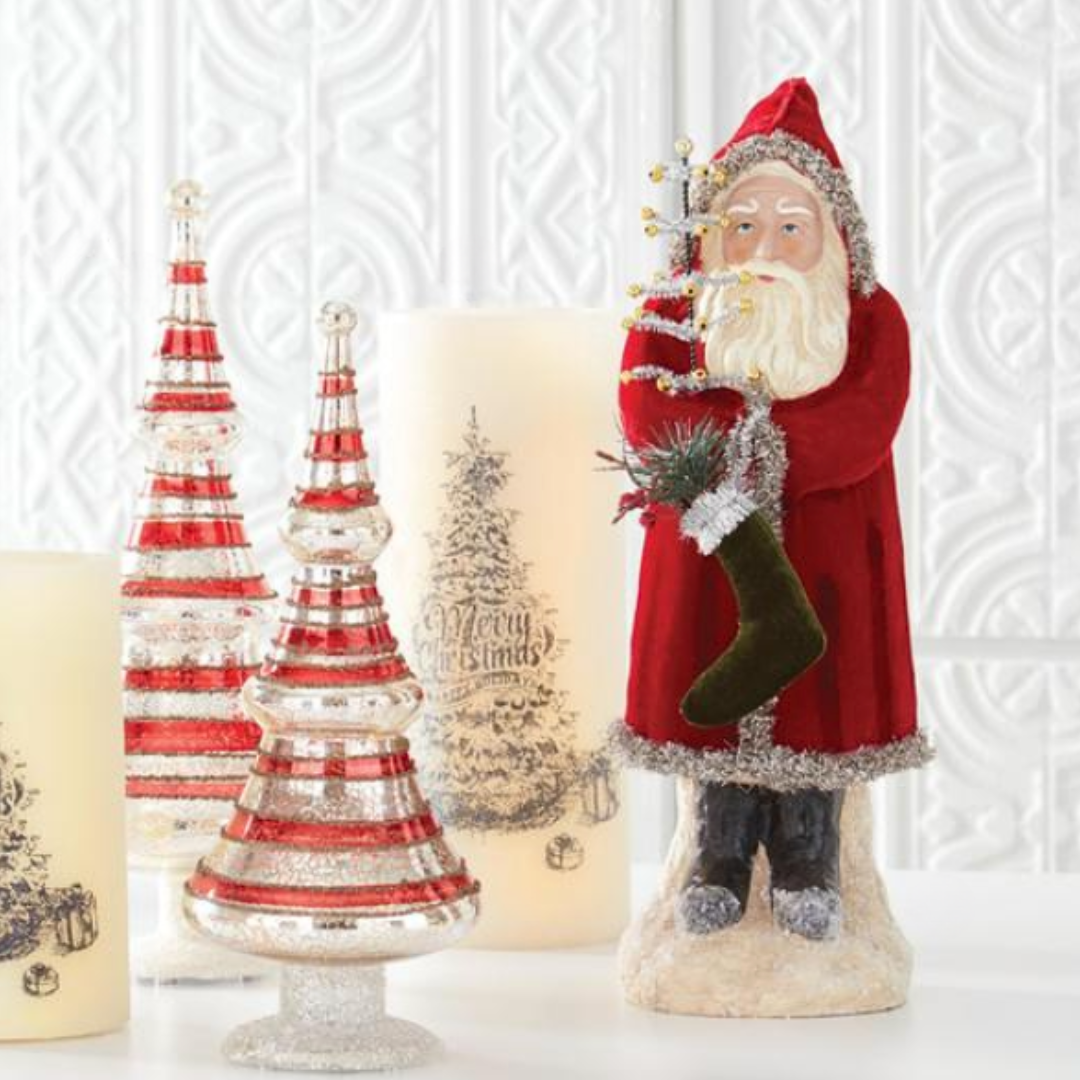 Decorative Santa Claus figure with Christmas trees and candles on a white background