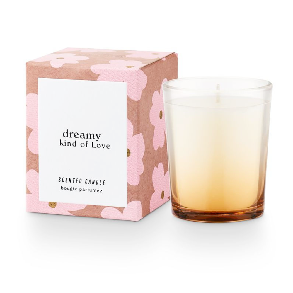 Scented candle with gradient design and floral packaging on a white background