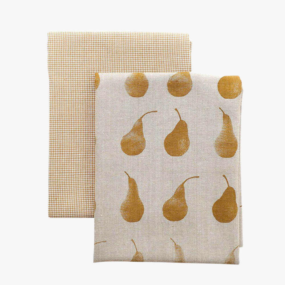 Two cotton tea towels, one with a Duchess Pear motif and the other featuring a gold and cream mini check pattern.