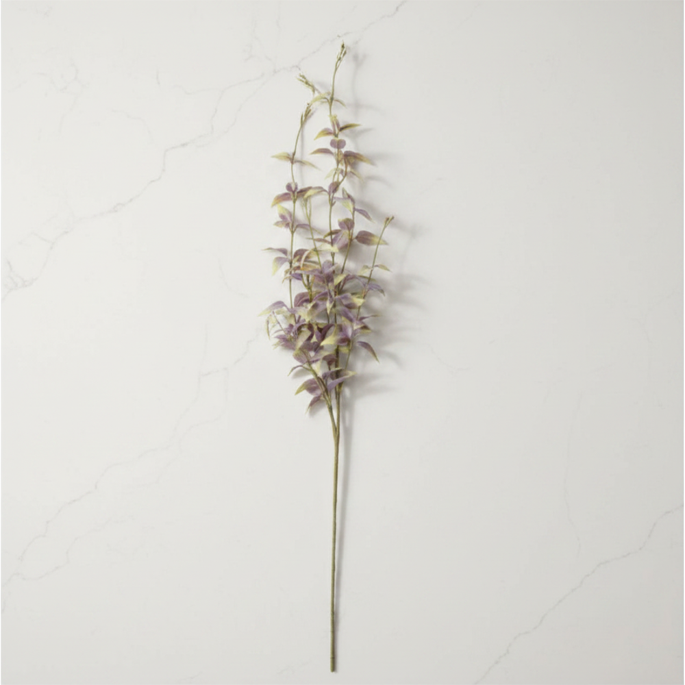 Artificial flower stem with purple flowers on a white background