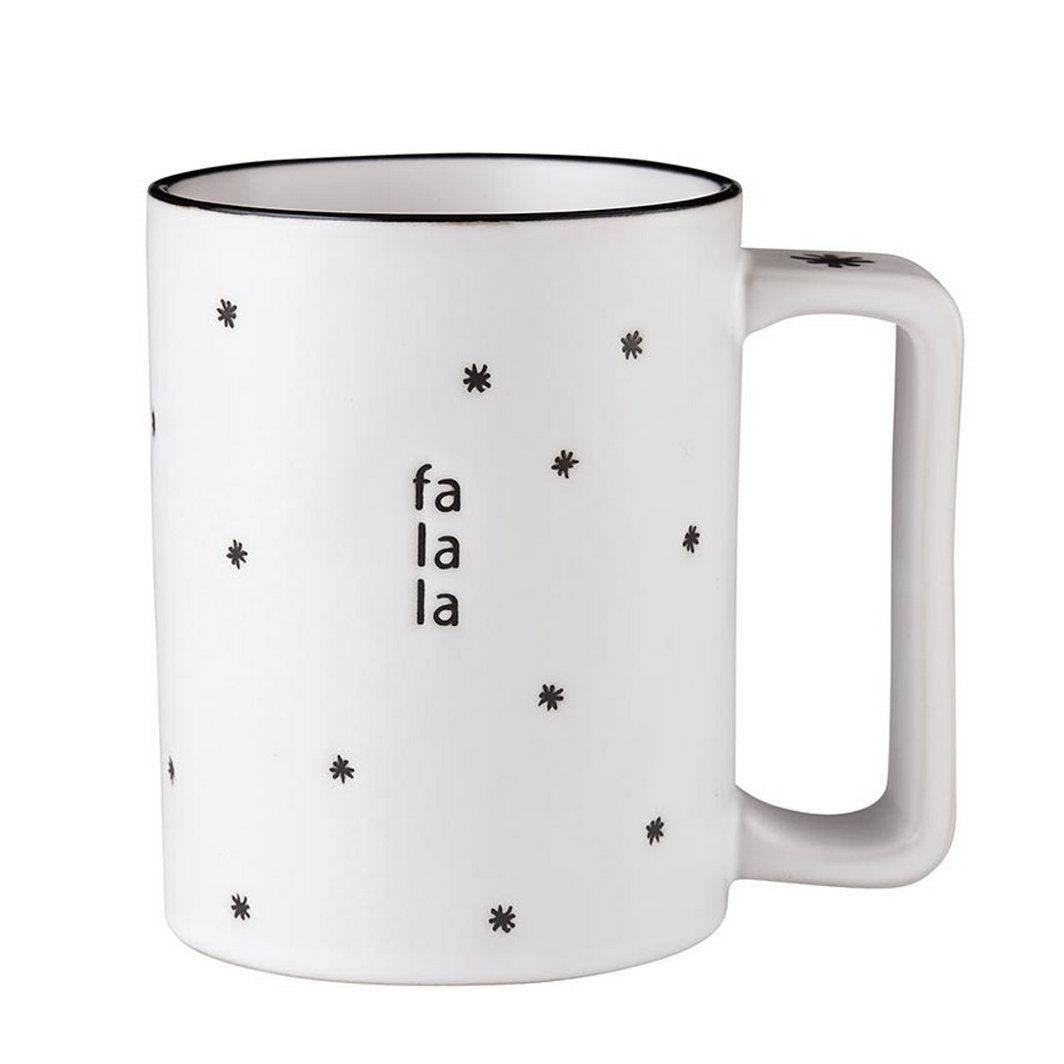 A white ceramic mug with the text 'FA LA LA' and star icons on it.