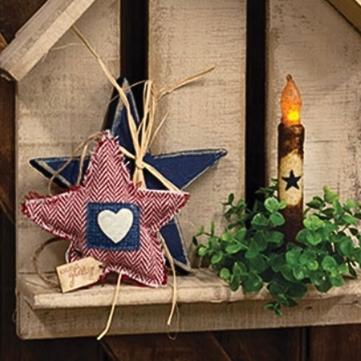 Decorative star with a heart and a candle on a wooden surface