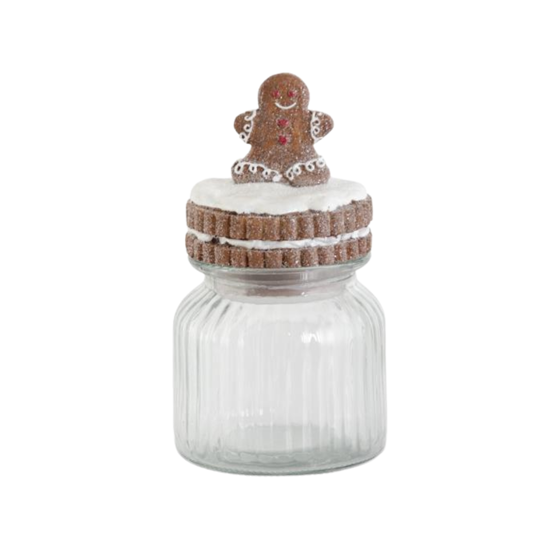 Decorative glass jar with a gingerbread man on top against a white background