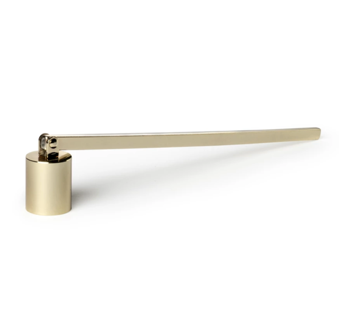 Gold-colored candle snuffer with a long handle on a white background