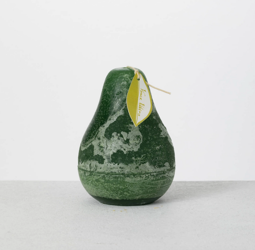 Unscented green pear-shaped candle displayed on a stoneware tray.