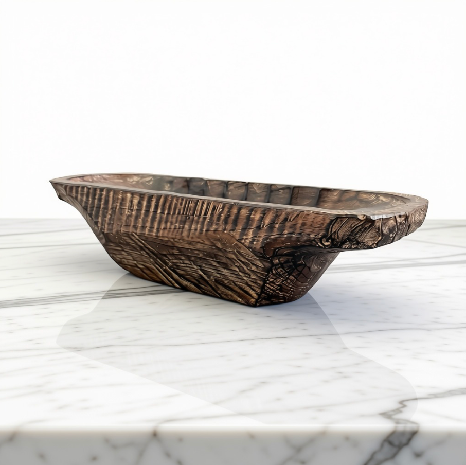 A rustic dark brown carved wooden bowl with a rough, textured surface and natural edge, displayed on a white marble surface against a white background.