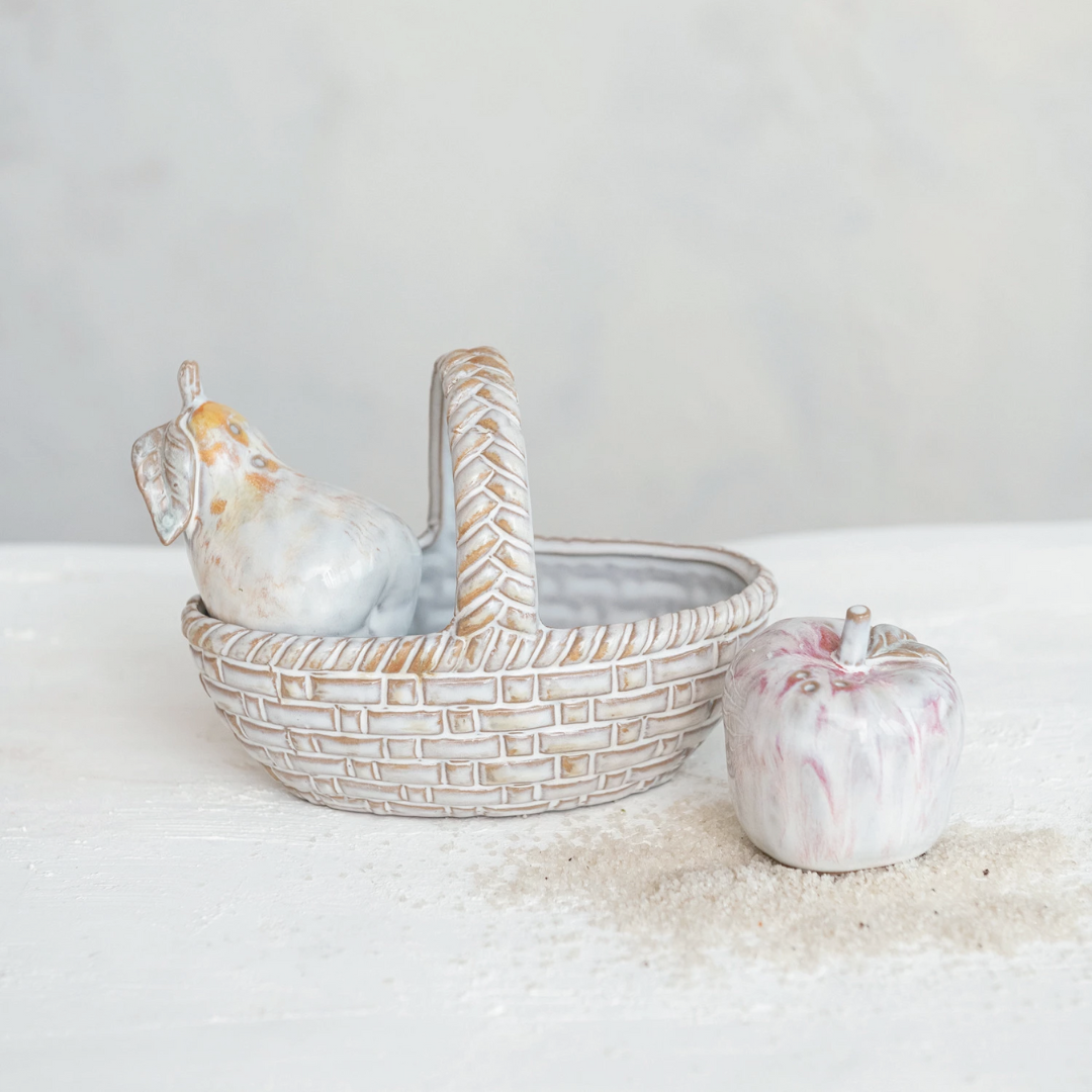 A stoneware salt and pepper shaker set with a basket. The shakers are pear-shaped and the basket has a handle.
