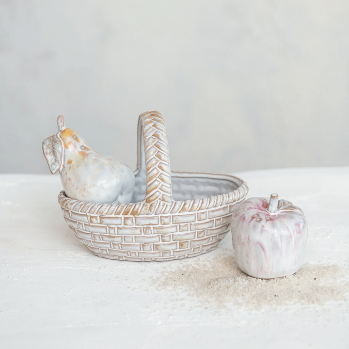 A stoneware salt and pepper shaker set with a basket. The shakers are pear-shaped and the basket has a handle.