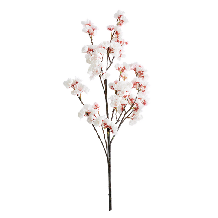 Artificial cherry blossom branch with white and pink flowers on a white background