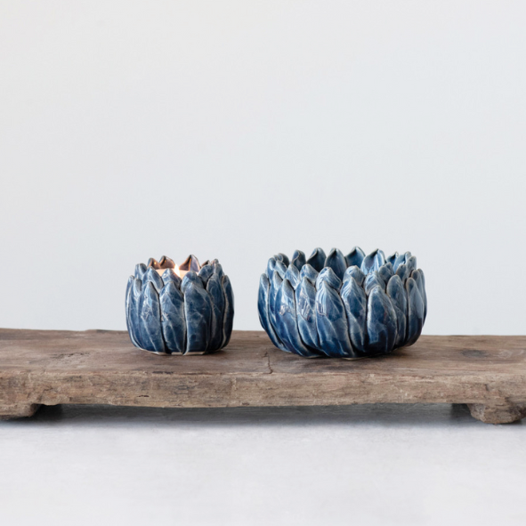 Two blue ceramic bowls on a wooden tray against a white background