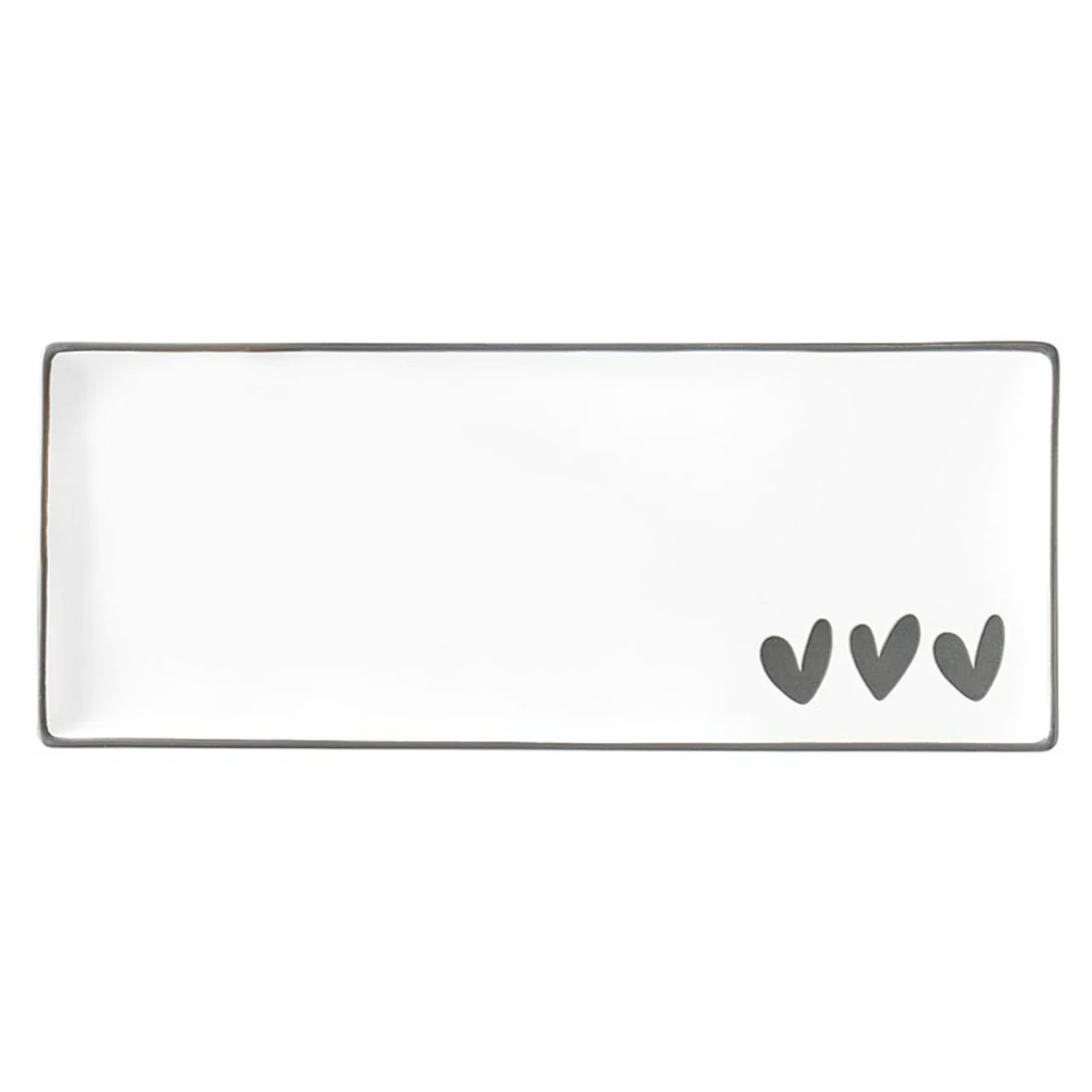 Rectangular white plate with three gray hearts on a white background