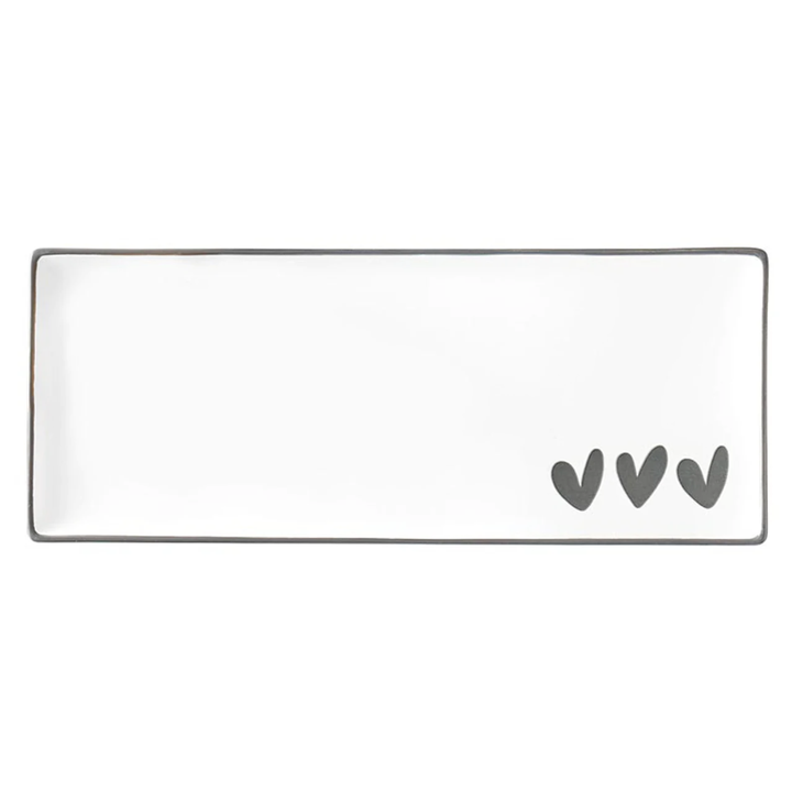 Rectangular white plate with three gray hearts on a white background
