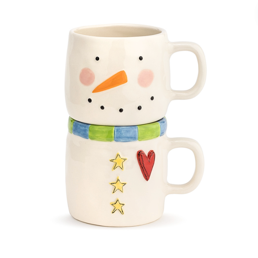 Two Stoneware mugs designed to resemble a snowman with a stackable design, featuring a carrot, heart, and stars on the snowman's face.