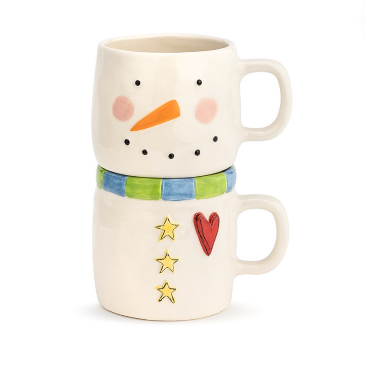 Two Stoneware mugs designed to resemble a snowman with a stackable design, featuring a carrot, heart, and stars on the snowman's face.