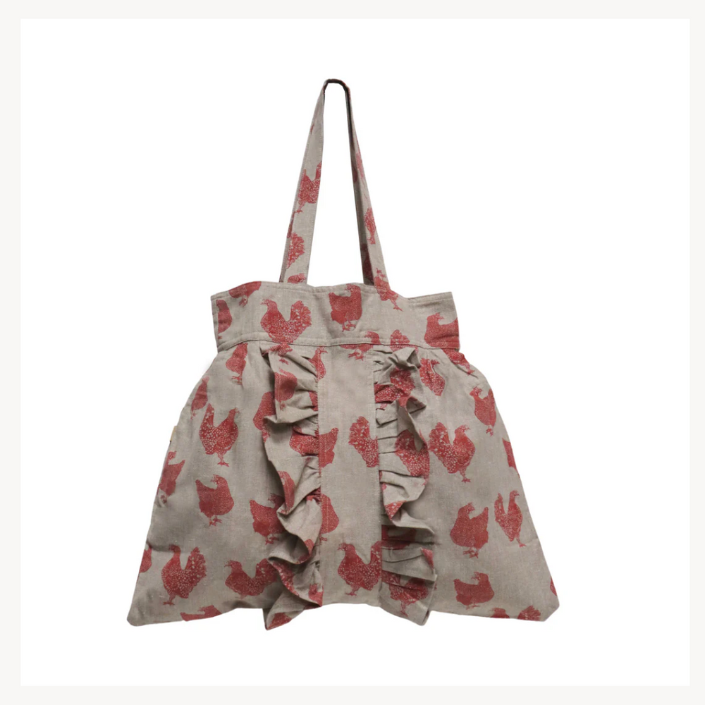 A shopping tote with a fig color featuring a chicken pattern, with ruffles on the front and back.