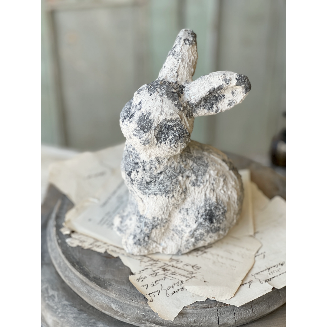 Decorative rabbit figurine on a surface with a blurred background
