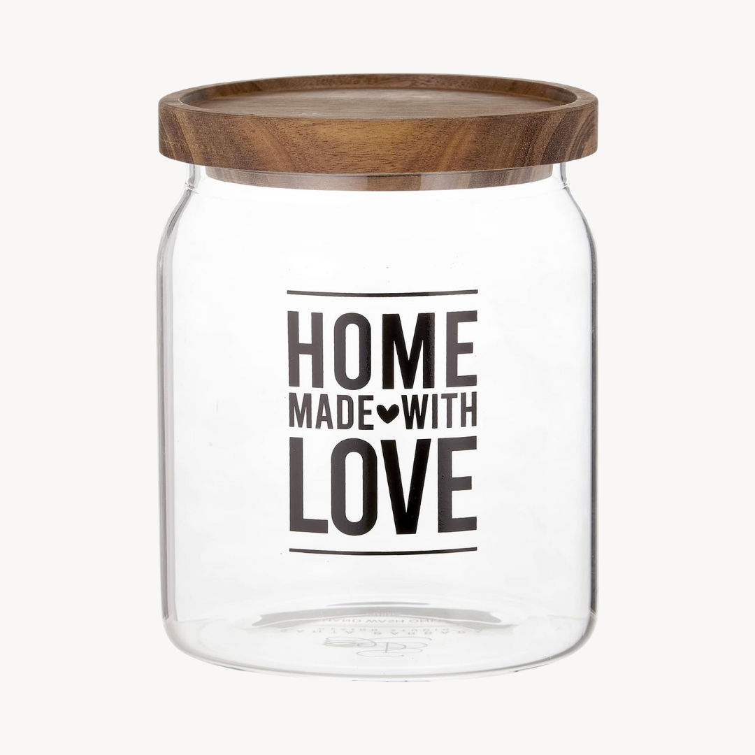 Clear glass jar with wooden lid and 'Home Made with Love' text on a white background