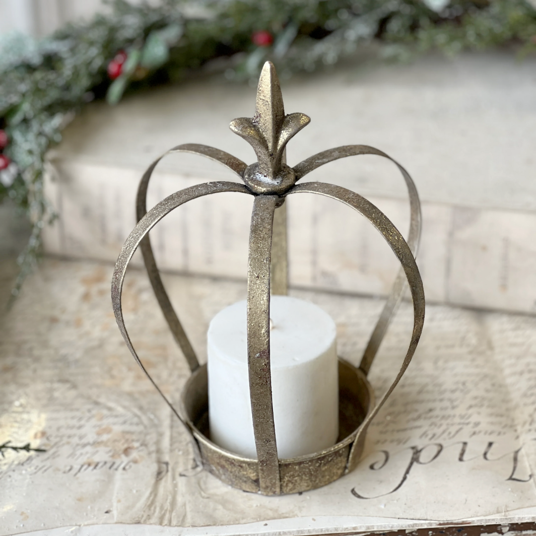 Decorative metal lantern with a candle inside on a textured surface with a blurred natural background
